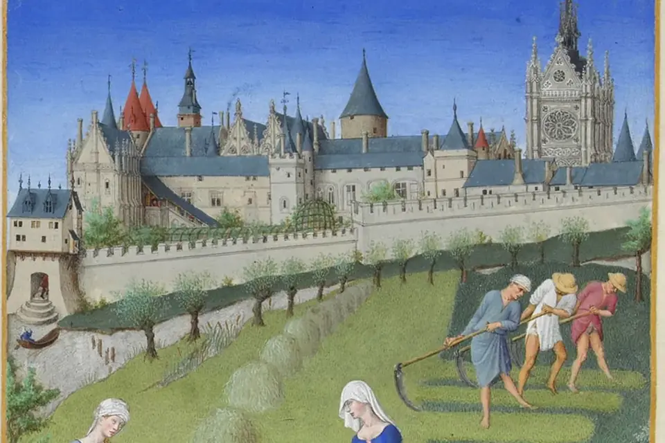 Miniature médiévale du mois de juin : paysans fauchant et ratissant le foin devant un palais aux tours gothiques, sous un ciel bleu